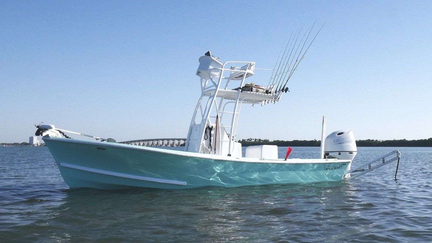 The 23 foot Hanson tower boat on calm water with the bridge behind it
