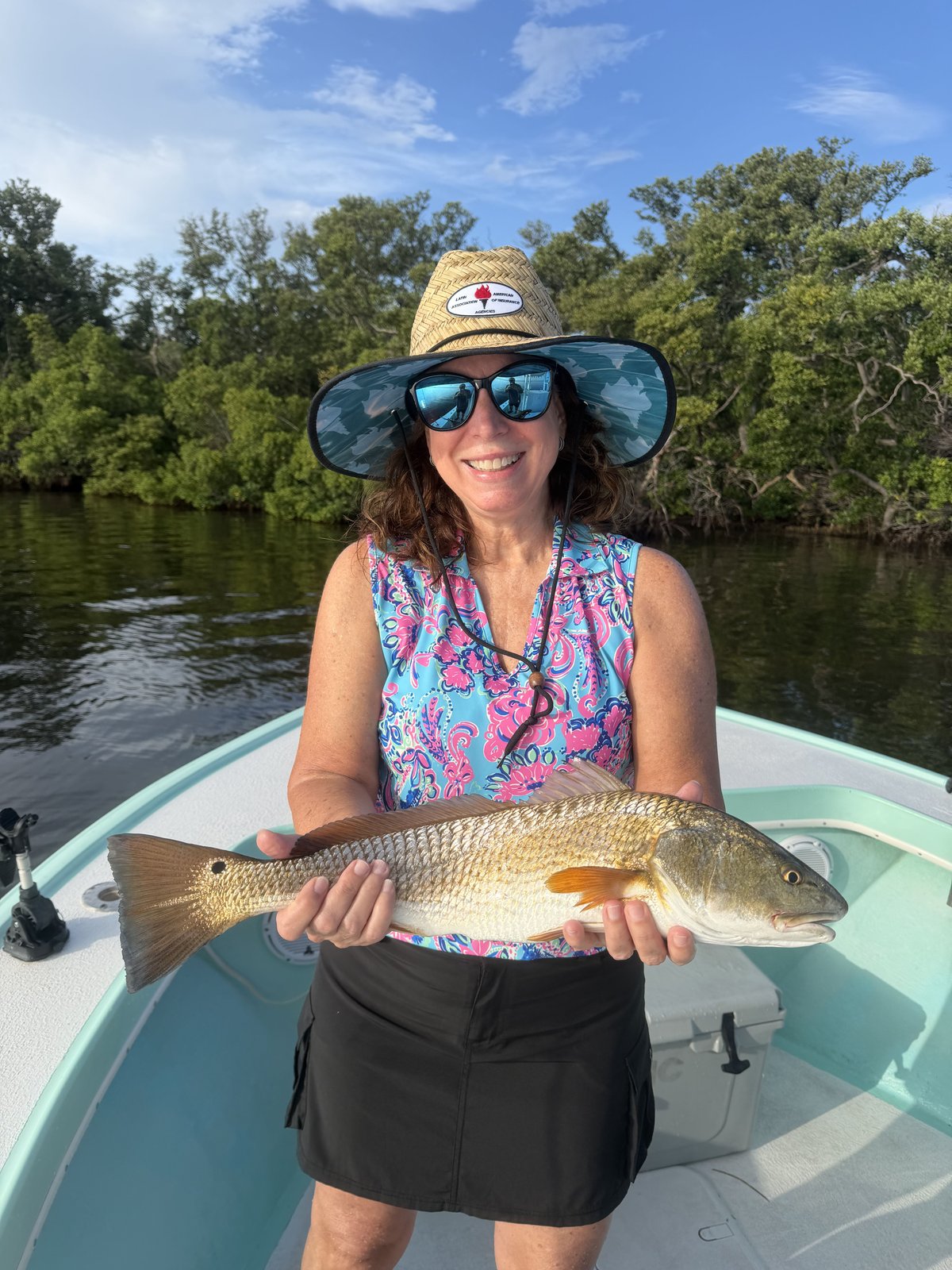 A guest holding a redfish on the flats in Tampa Bay