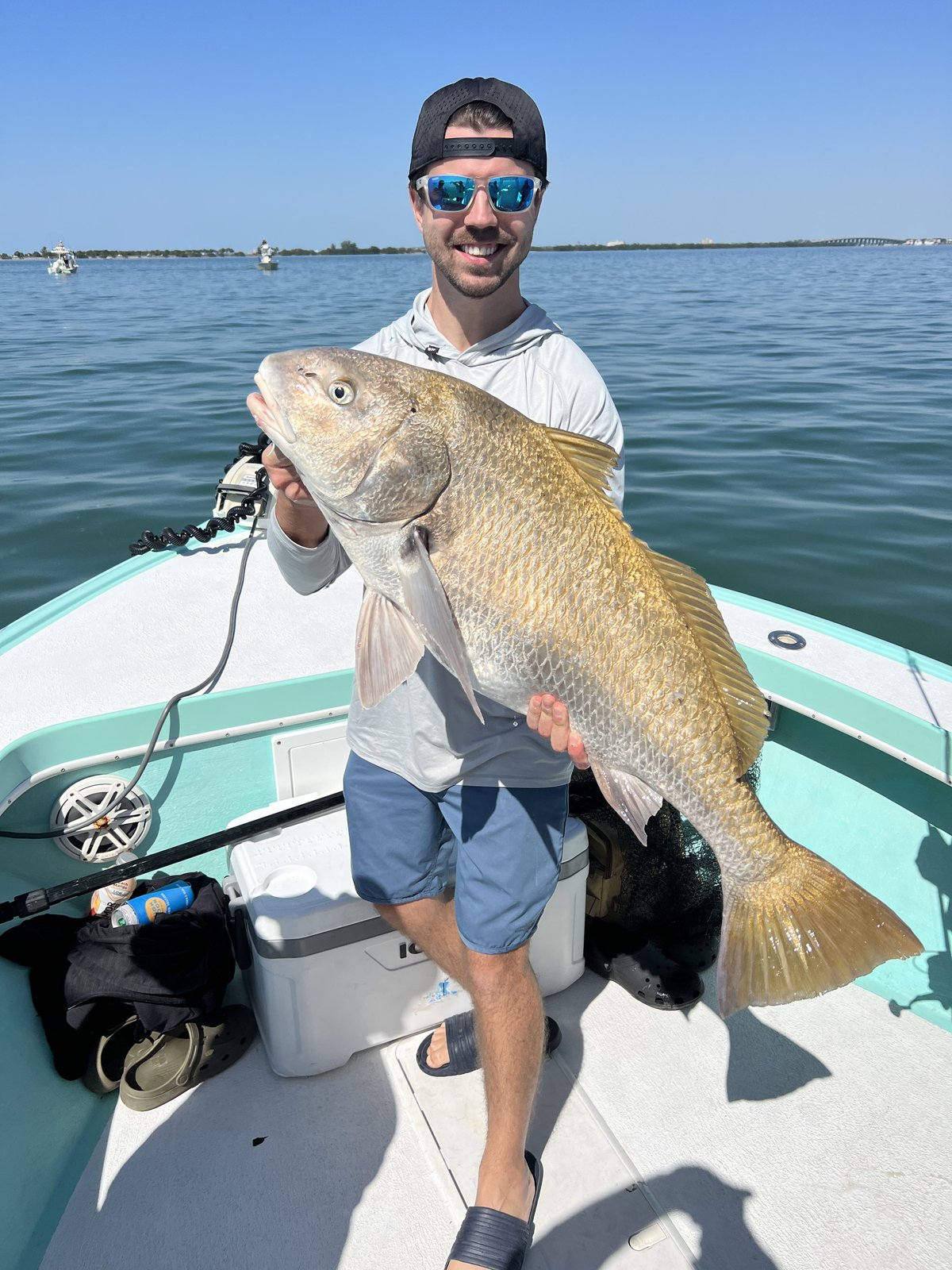 Two guests with a redfish on an inshore charter out of Saint Petersburg