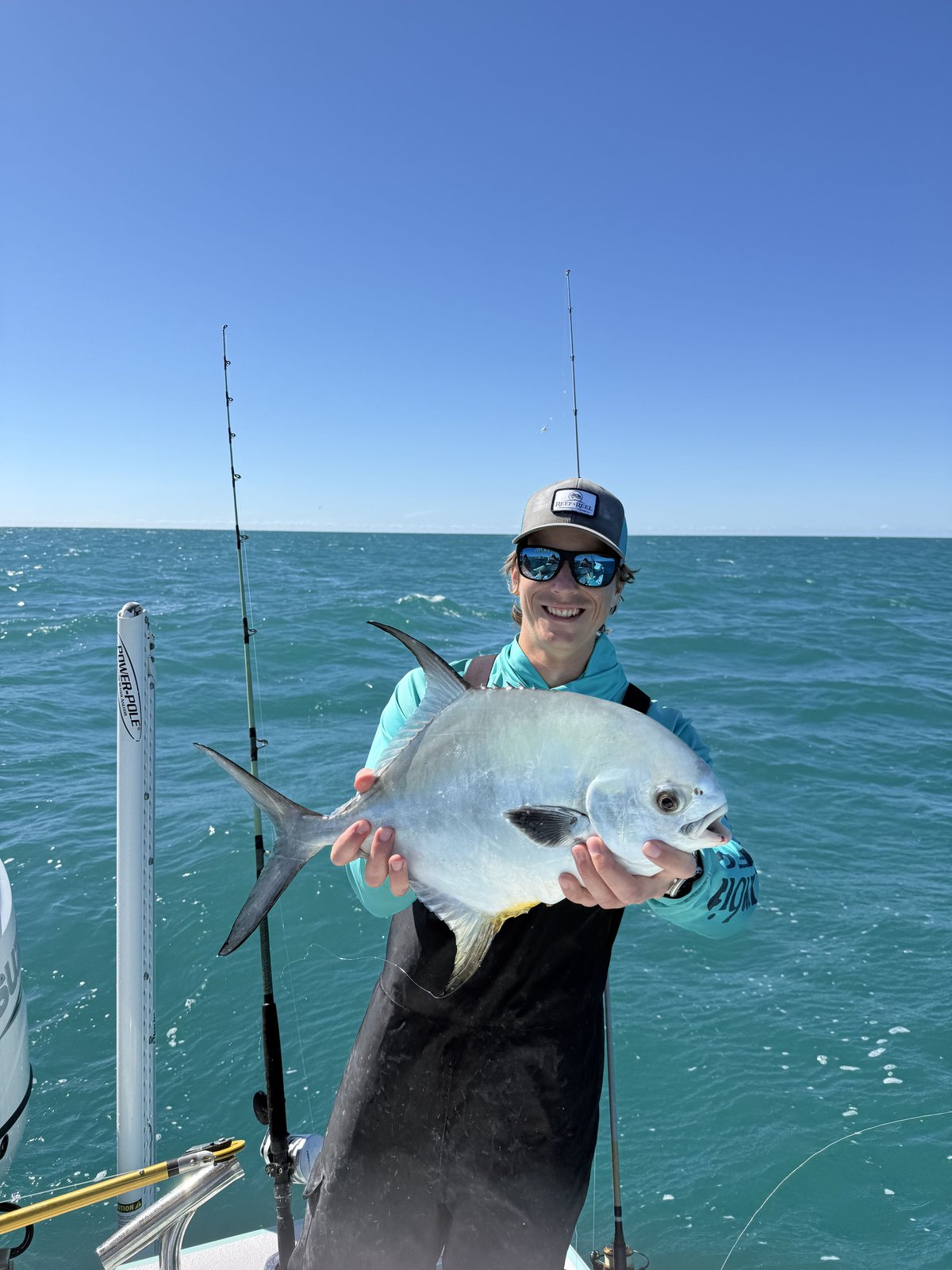An angler holding a permit caught on a nearshore Gulf charter
